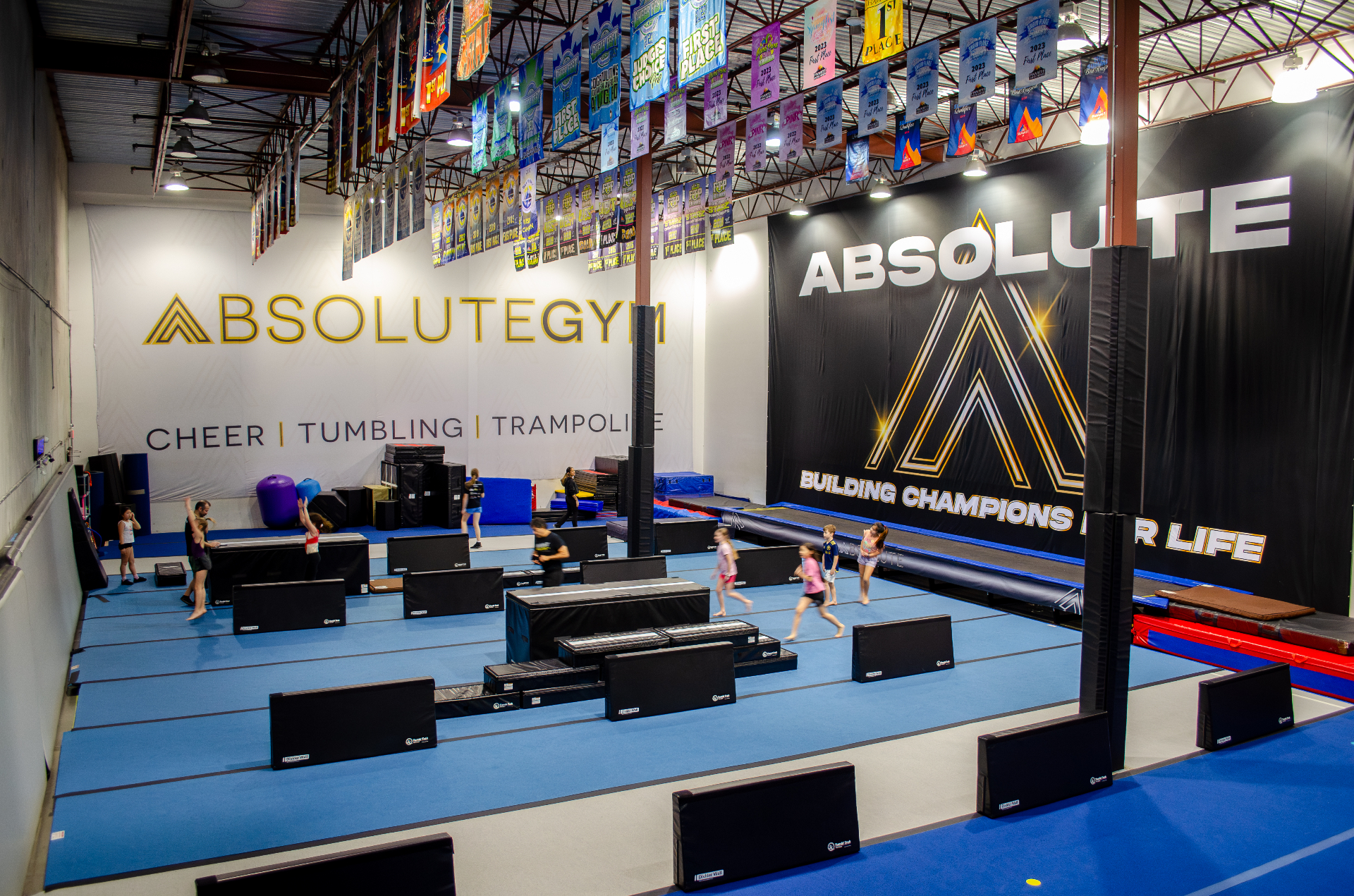 Athletes tumbling on the gym floor at Absolute Gym